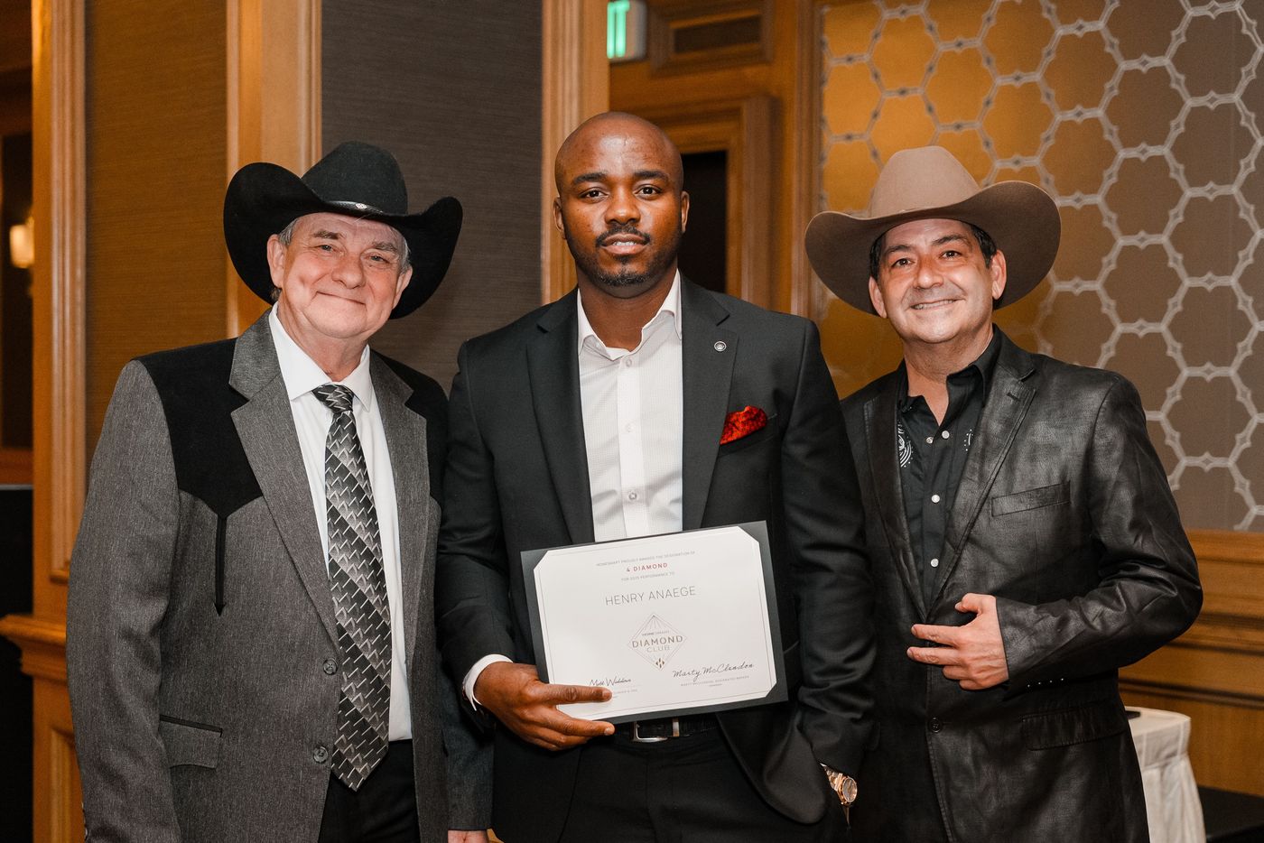 Henry with his 4 Diamond certificate between two colleagues