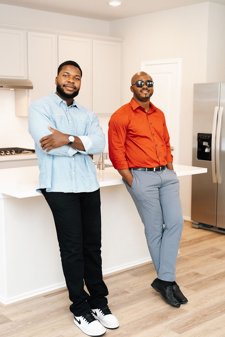 Henry and his client leaning on the kitchen island