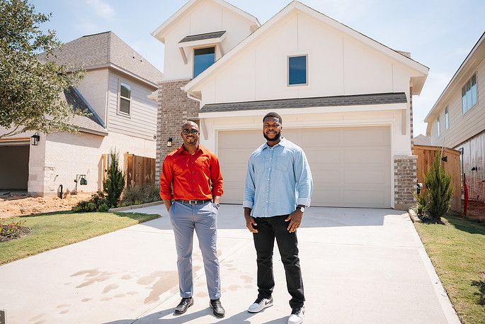Henry and his client on the driveway of the new home